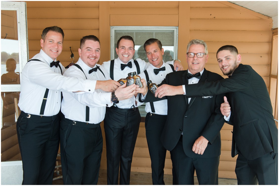 Groom and groomsmen holding whisky bottles | Brittland Manor | Rob Korb | My Eastern Shore Wedding 