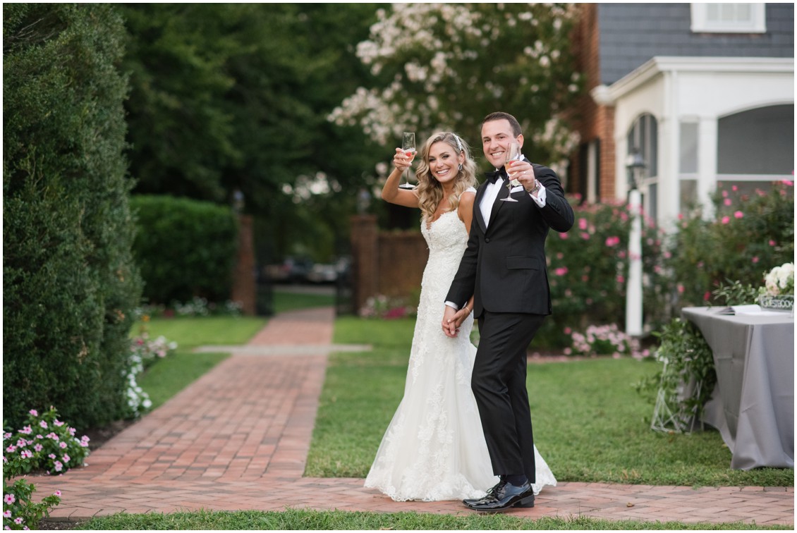 Bride and groom celebrating after ceremony holding champagne | Brittland Manor | Rob Korb | My Eastern Shore Wedding 