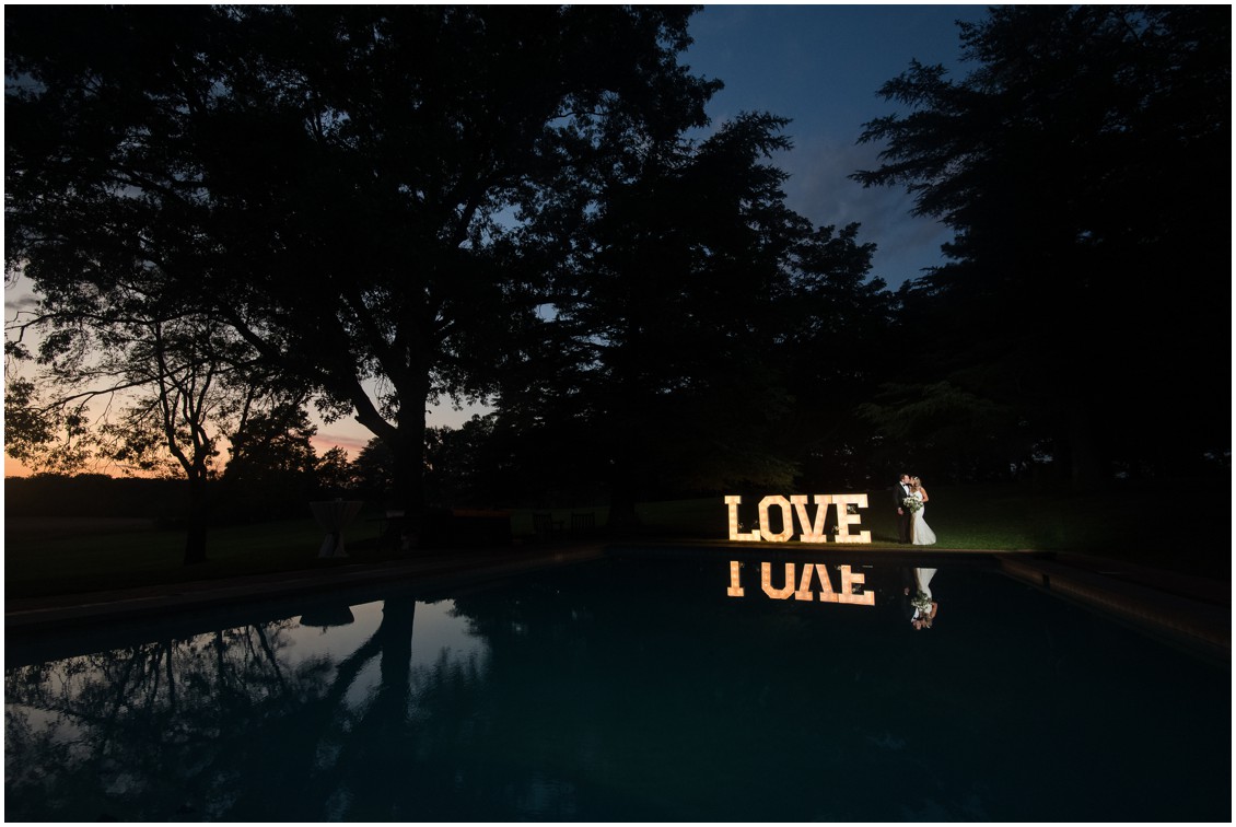 Bride and groom with lighted love sign | Brittland Manor | Rob Korb | My Eastern Shore Wedding 